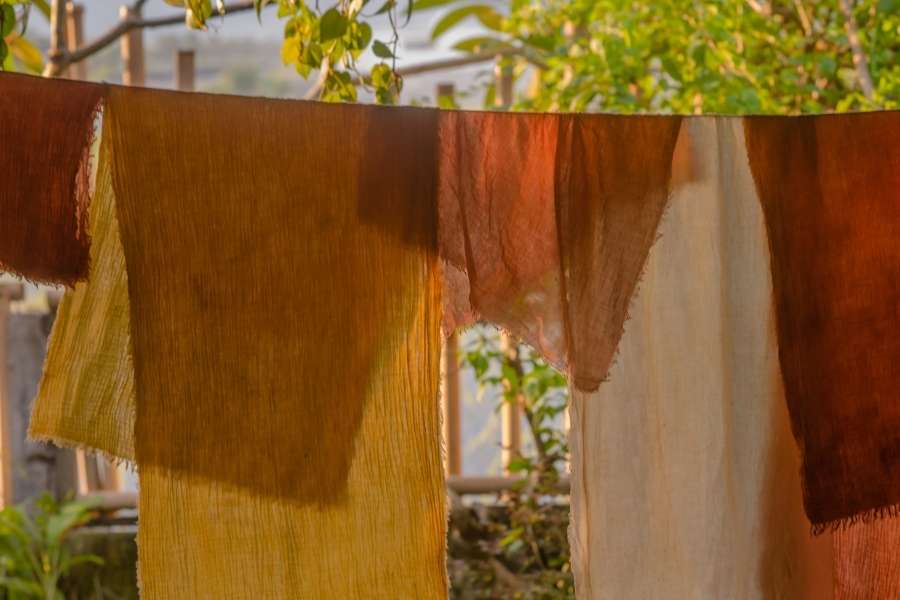 Tissus colorés suspendus pour sécher après une teinture naturelle des tissus.